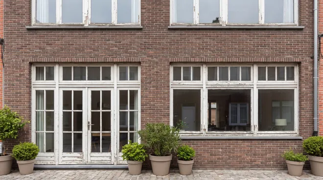 BEFORE photo — old single-glazed windows with glazing bars