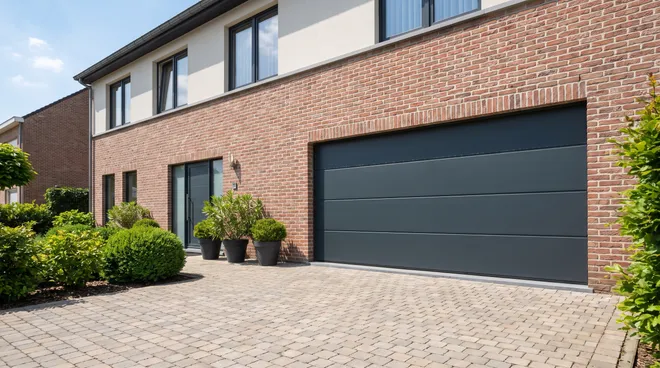 AFTER photo — anthracite sectional door, motorised and insulated