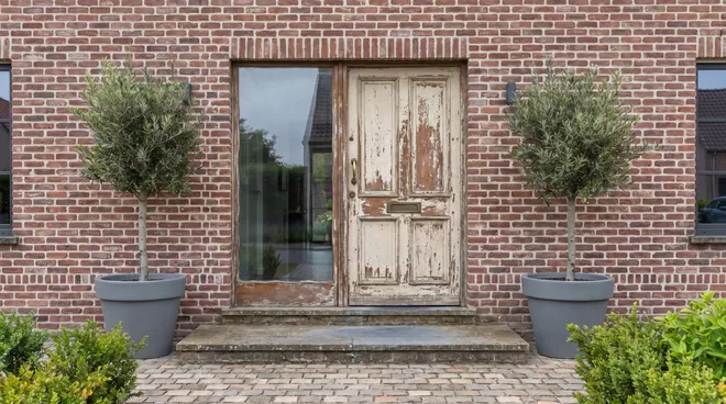 BEFORE photo — old single-glazed wooden entrance door